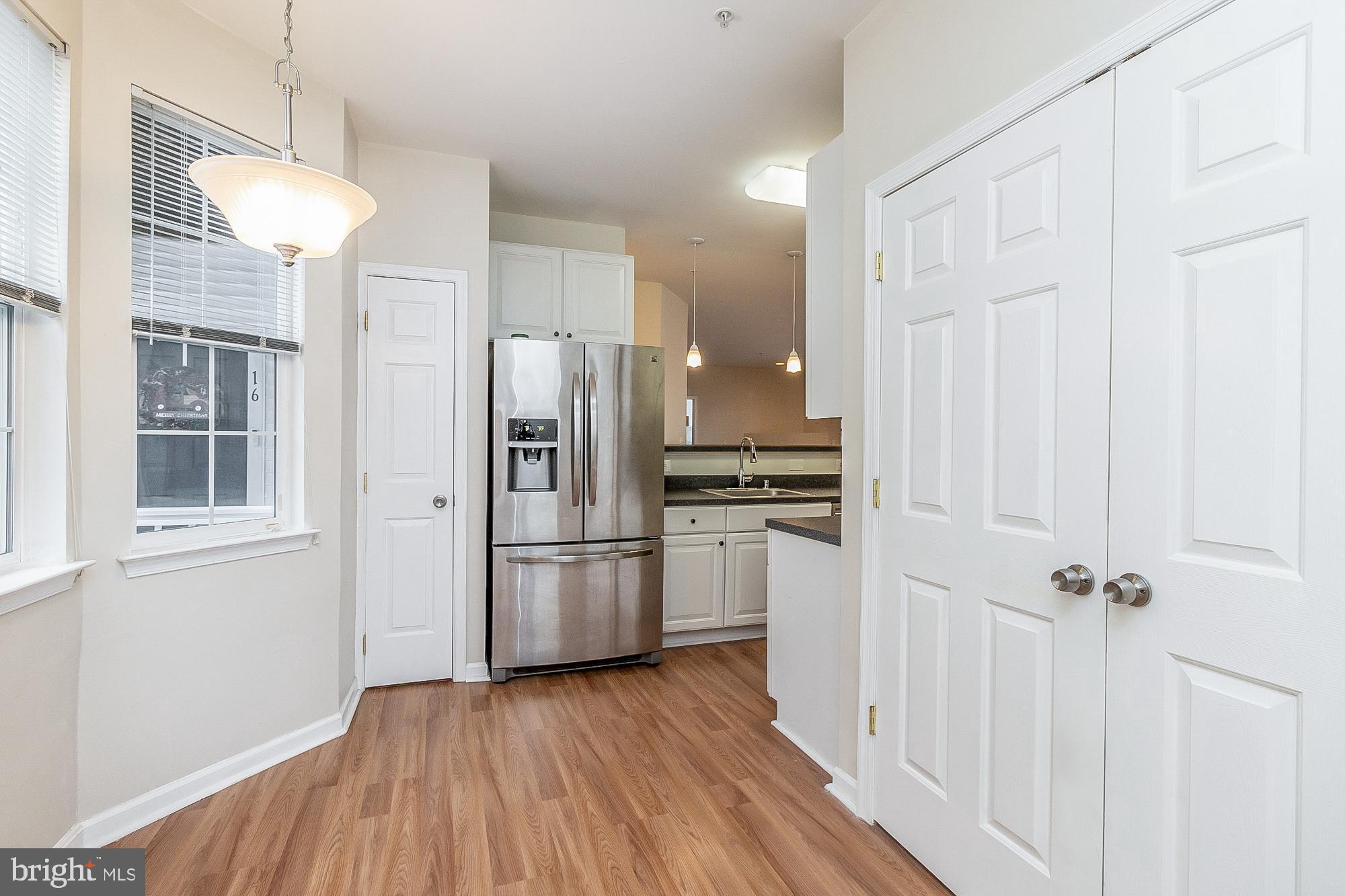 18 Hawk Rise Lane, Unit 205 Owings Mills, MD 21117 - Photo 22 of 29 a kitchen with stainless steel appliances a refrigerator and a stove top oven