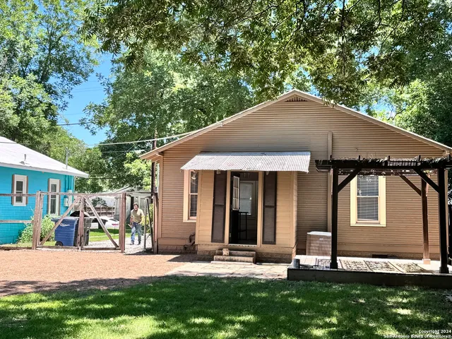 a backyard of a house with yard and outdoor seating