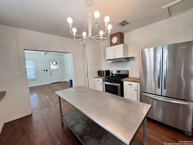 a kitchen with cabinets and stainless steel appliances