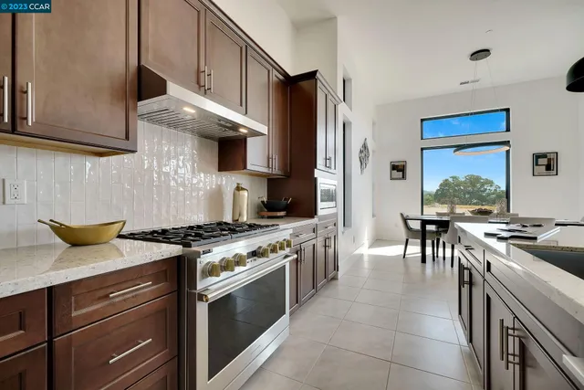 a kitchen with stainless steel appliances granite countertop a stove and a refrigerator