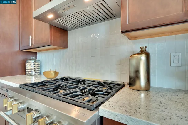 a stove top oven sitting inside of a kitchen