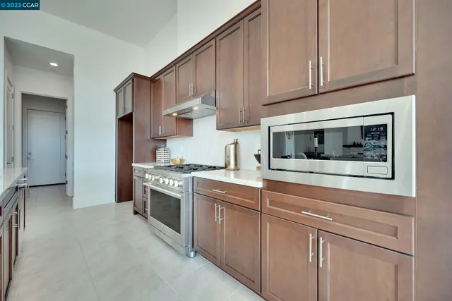 a kitchen with stainless steel appliances granite countertop a stove and a refrigerator
