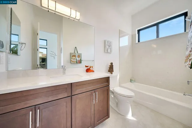 a bathroom with a sink toilet and mirror