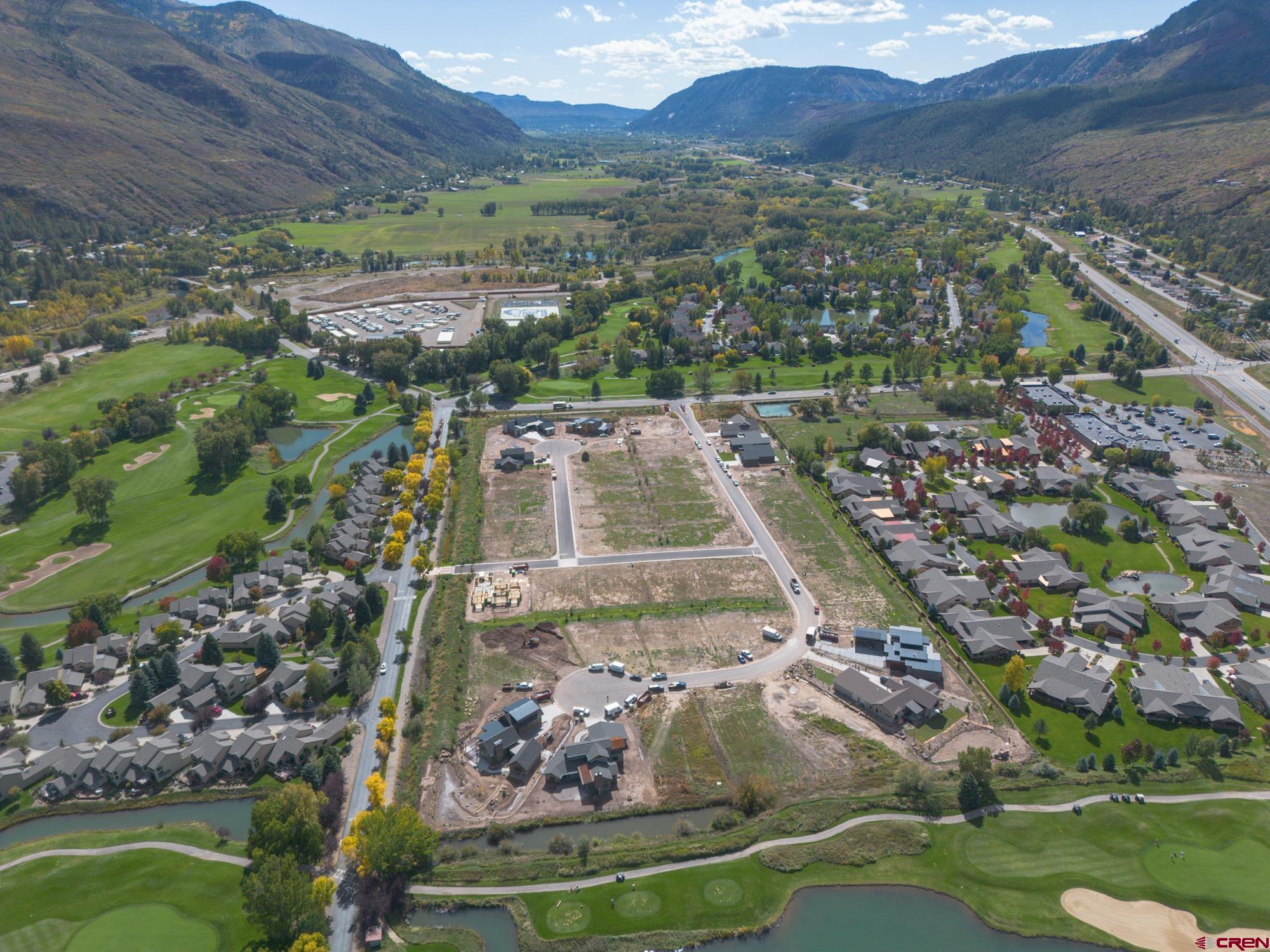 an aerial view of residential houses with outdoor space