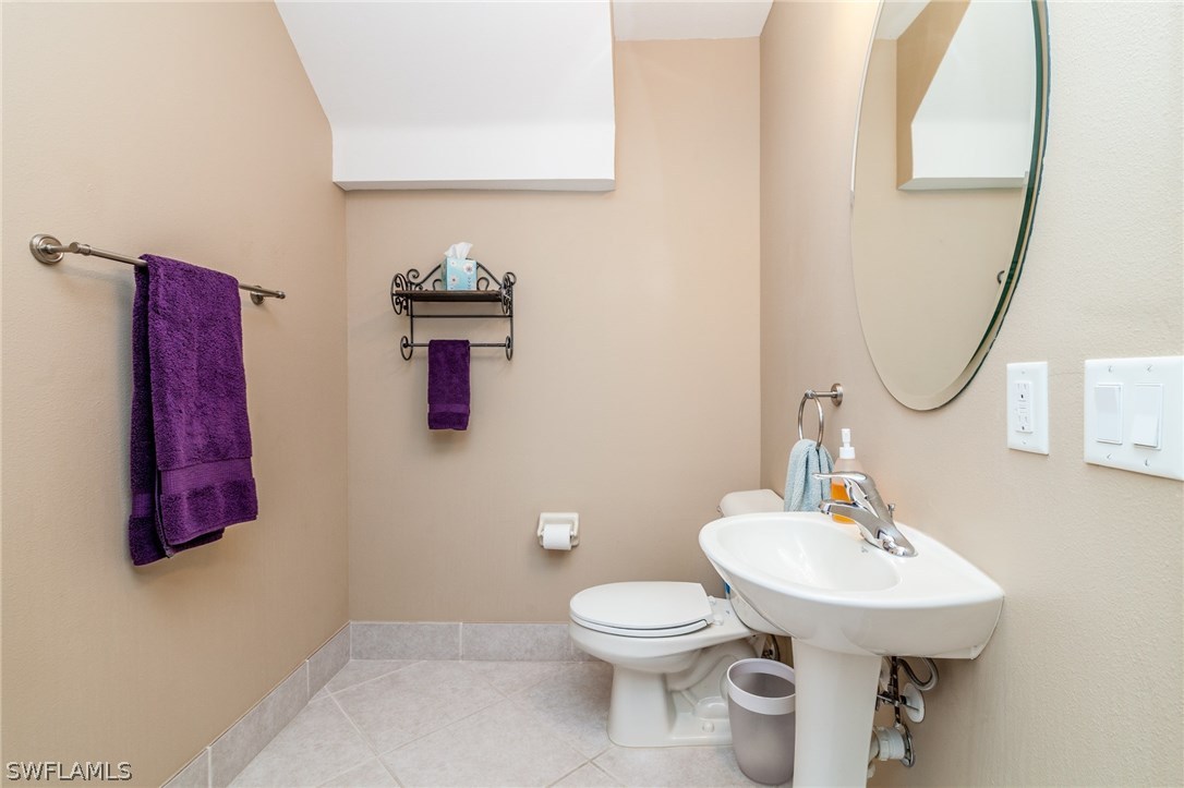 3968 Cherrybrook Loop Fort Myers, FL 33966 - Photo 8 of 16 a bathroom with a toilet a sink and mirror