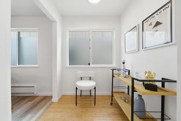 a view of a dining room with furniture and wooden floor