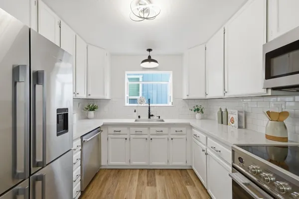 a kitchen with appliances and cabinets
