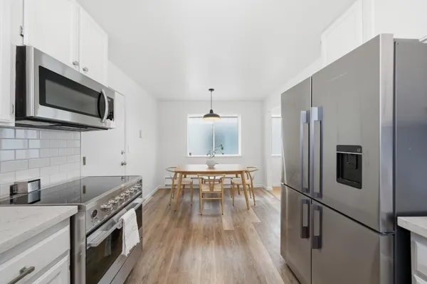 a bedroom with a bed and a potted plant