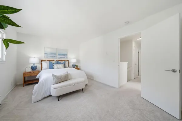 a bedroom with a bed and a lamp