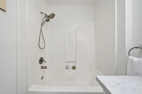 a balcony with wooden floor table and chairs