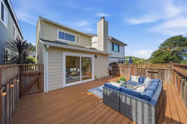 a aerial view of a house with a garage and balcony