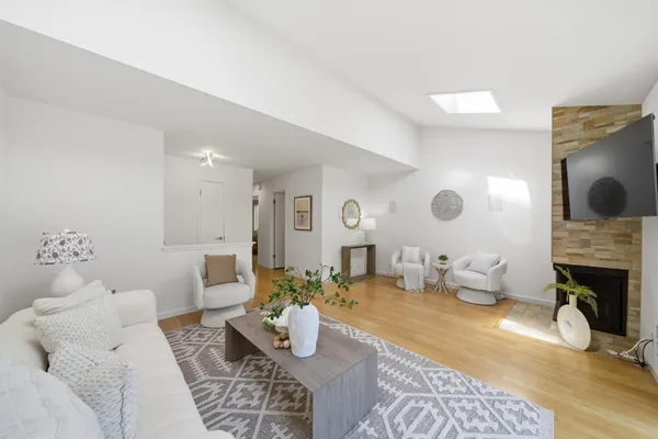 a living room with patio furniture and a potted plant