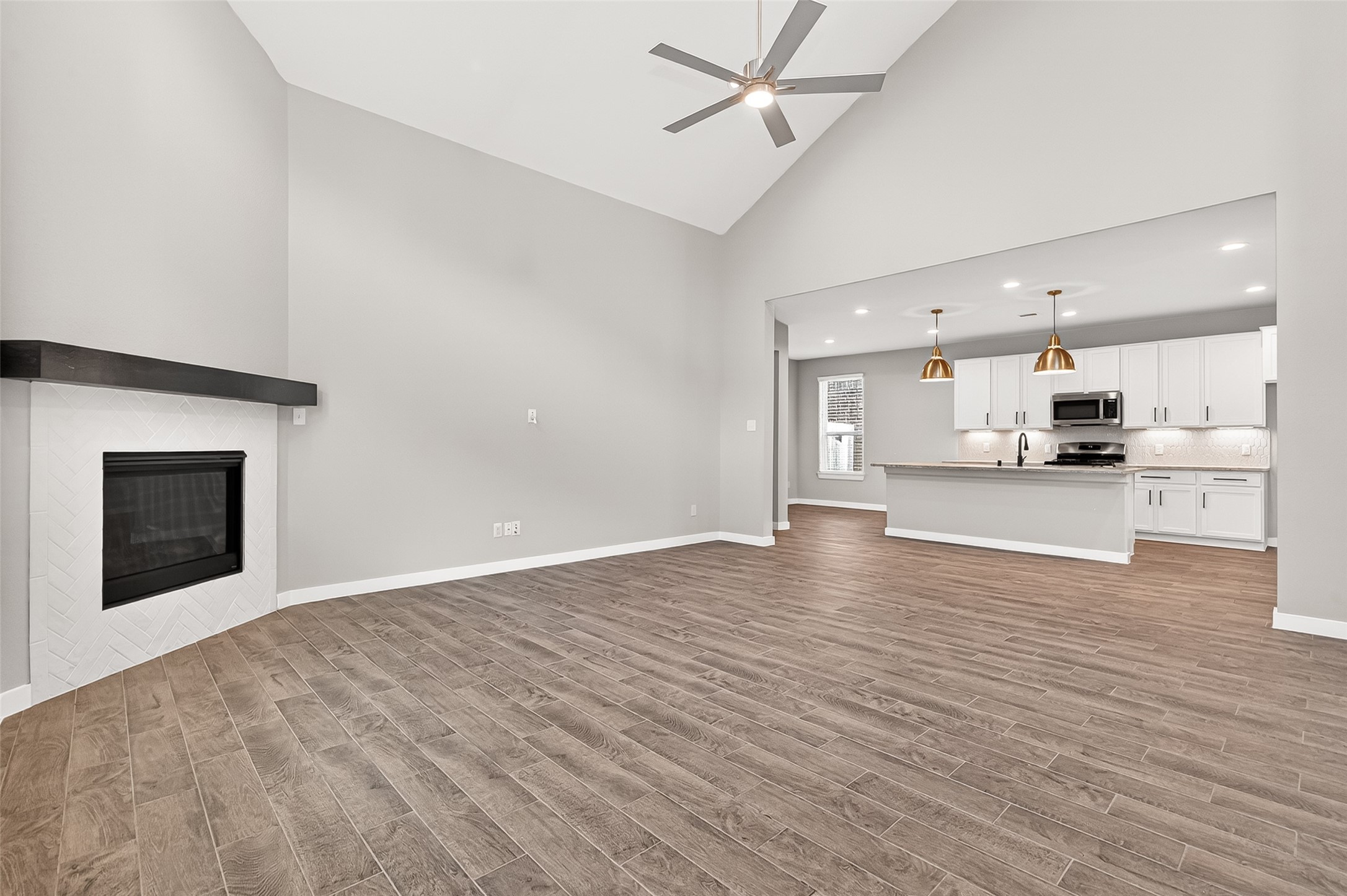 2142 Reed Cave Lane Spring, TX 77386 - Photo 14 of 50 a view of kitchen and empty room with wooden floor