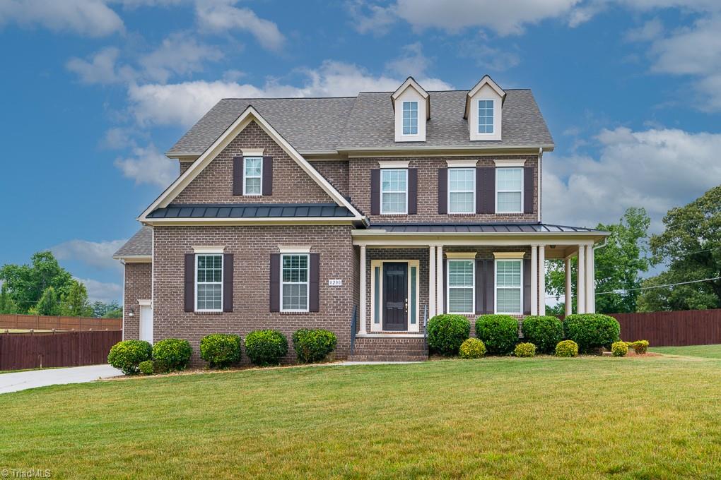 8200 Brotherstwo Road Colfax, NC 27235 - Photo 1 of 50 All brick home situated on corner lot with huge fenced yard and rocking chair front porch!