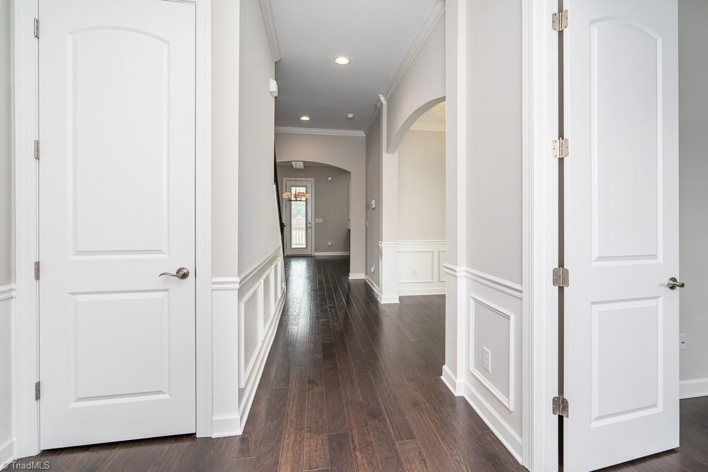 8200 Brotherstwo Road Colfax, NC 27235 - Photo 4 of 50 Spacious entry features chair and decorative moulding, sidelights around the front door, and coat closet. Door to the left leads to office or formal living room.