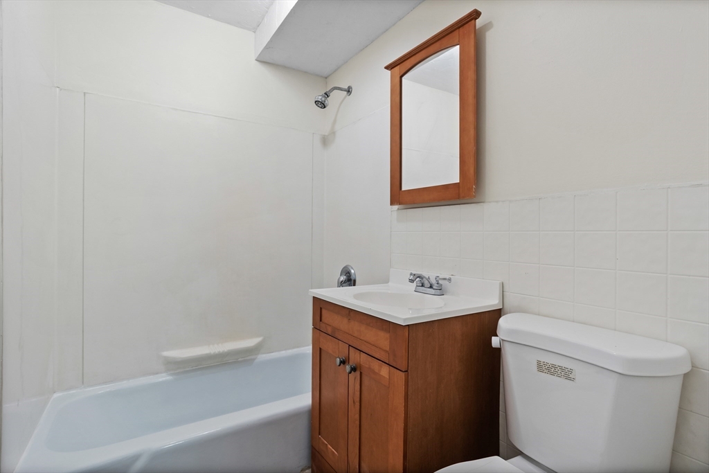 5 Turnpike Road, Unit 229 Townsend, MA 01469 - Photo 15 of 20 a bathroom with a toilet sink vanity tub and mirror
