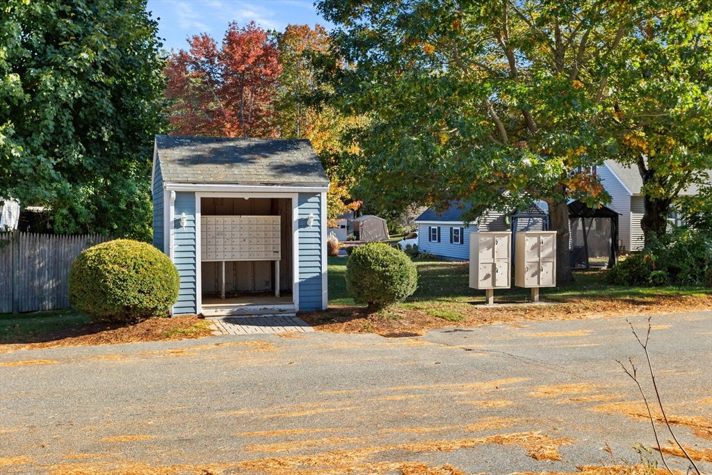 5 Turnpike Road, Unit 229 Townsend, MA 01469 - Photo 20 of 20 a view of a house with a yard and garage