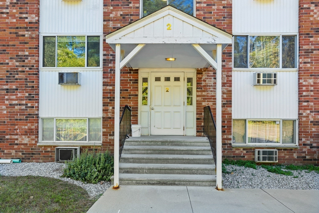 5 Turnpike Road, Unit 229 Townsend, MA 01469 - Photo 2 of 20 a front view of a house with a yard