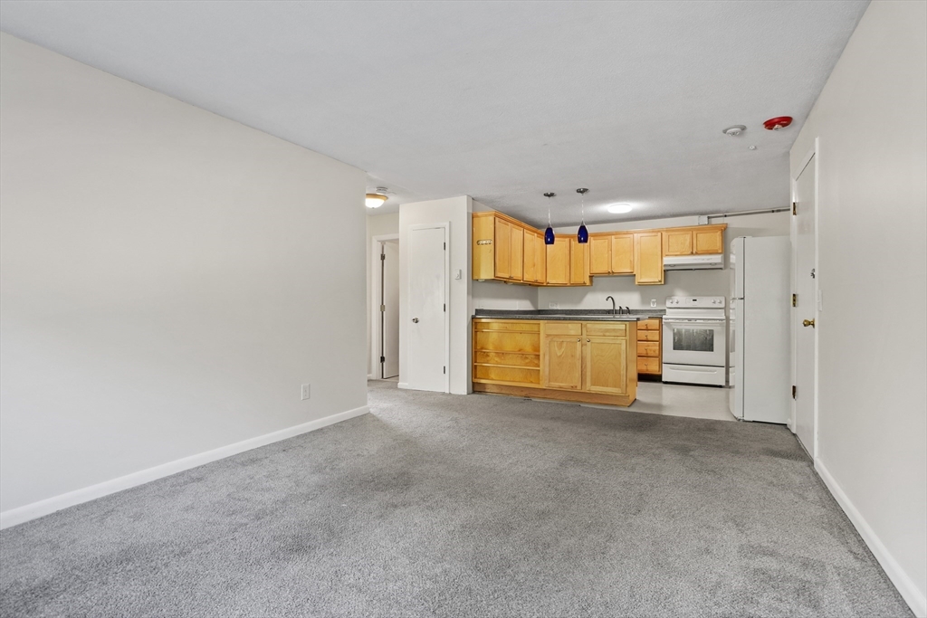 5 Turnpike Road, Unit 229 Townsend, MA 01469 - Photo 6 of 20 a view of a kitchen with a sink and a refrigerator