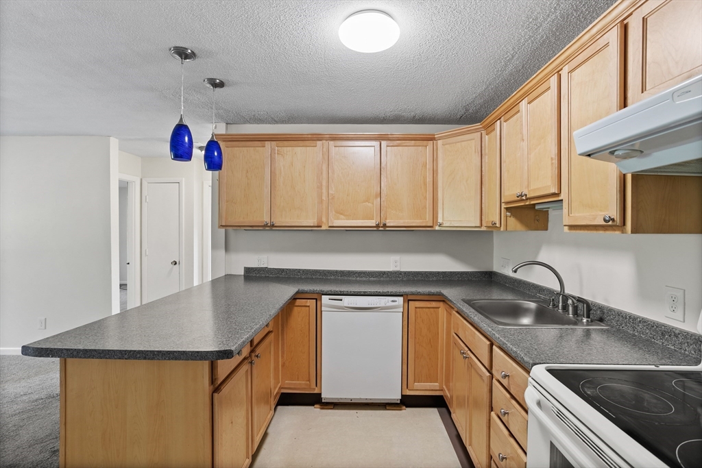5 Turnpike Road, Unit 229 Townsend, MA 01469 - Photo 8 of 20 a kitchen that has a sink cabinets counter space and appliances