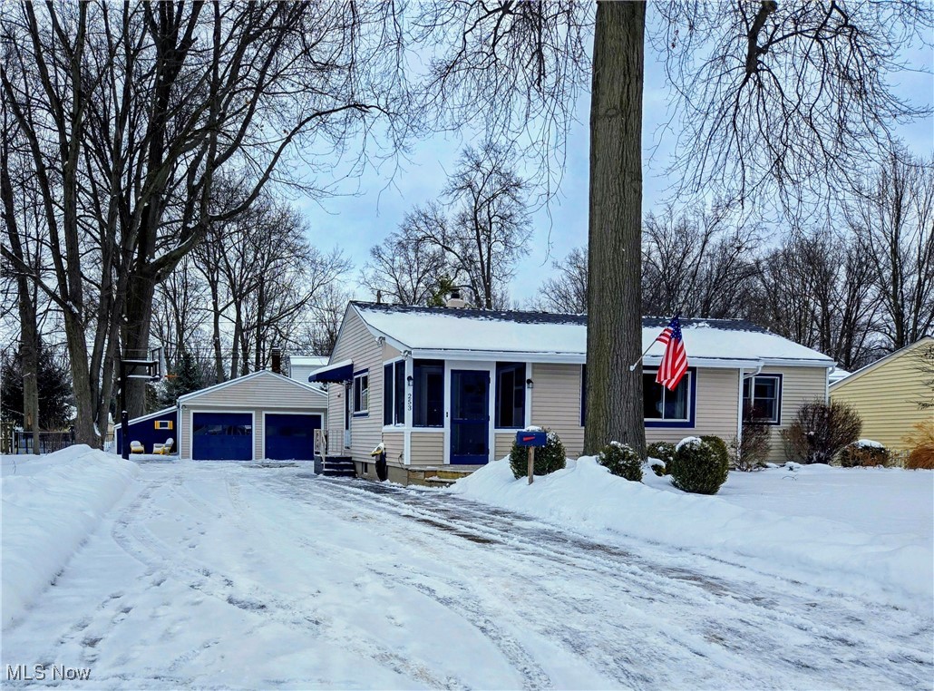 253 Sunset Road Avon Lake, OH 44012 - Photo 1 of 33 Ranch-style house featuring an outbuilding, a sunroom, a detached garage, and entry steps