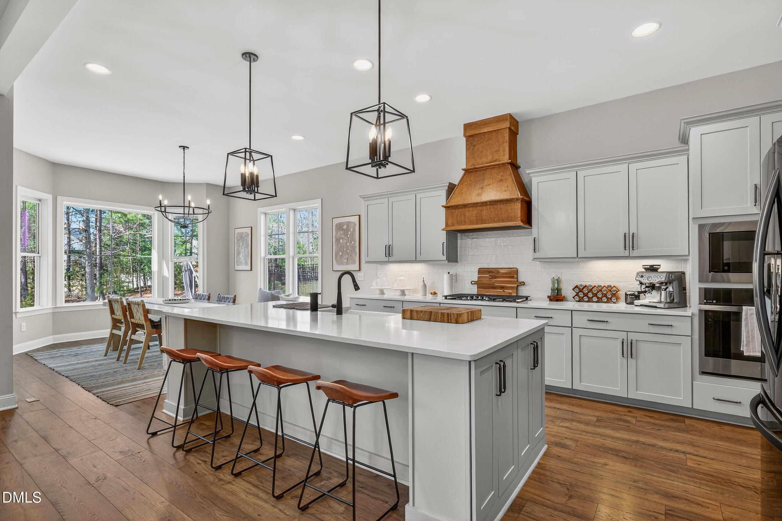 210 Lookout Ridge Pittsboro, NC 27312 - Photo 2 of 59 a kitchen with stainless steel appliances granite countertop a sink a stove and a wooden floor