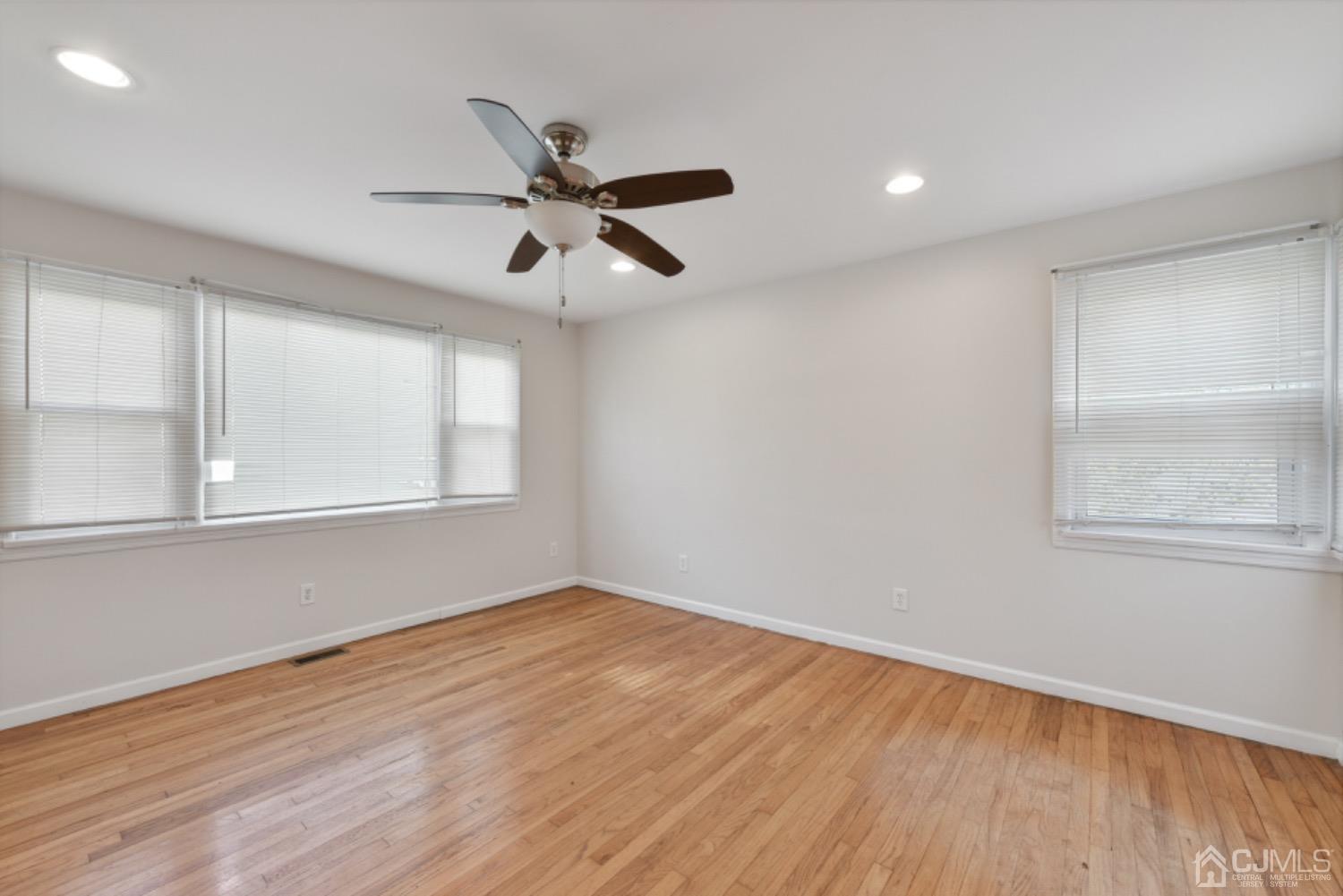 711 Old Post Road Edison, NJ 08817 - Photo 18 of 27 a view of empty room with wooden floor and fan