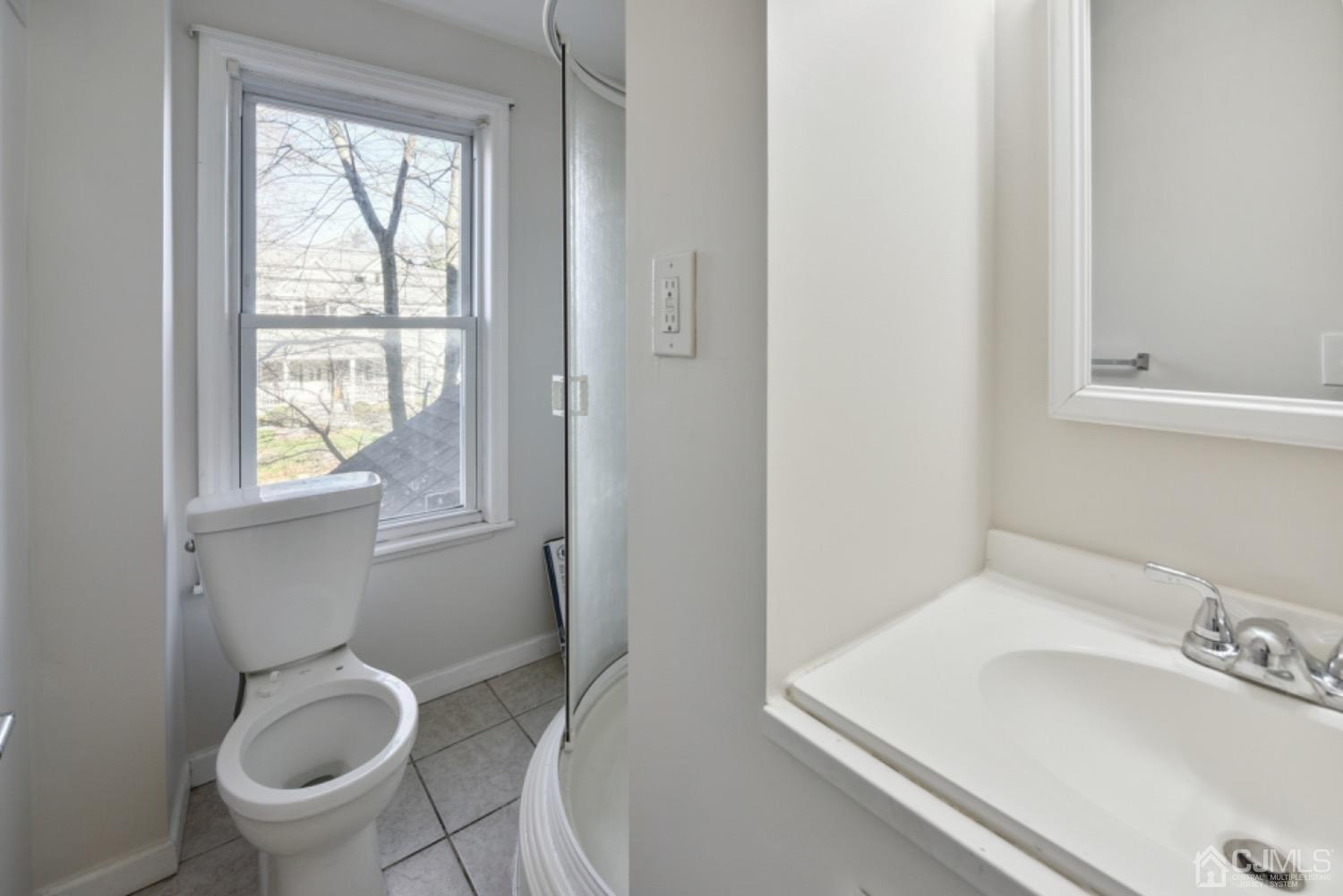 711 Old Post Road Edison, NJ 08817 - Photo 20 of 27 a bathroom with a sink toilet and window