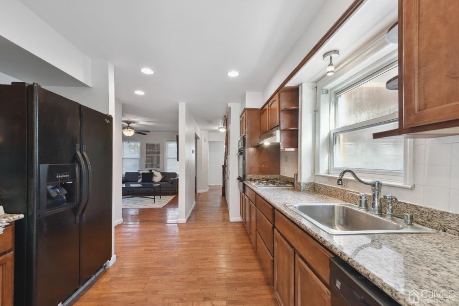 711 Old Post Road Edison, NJ 08817 - Photo 10 of 27 a kitchen with stainless steel appliances granite countertop a refrigerator a sink and a stove