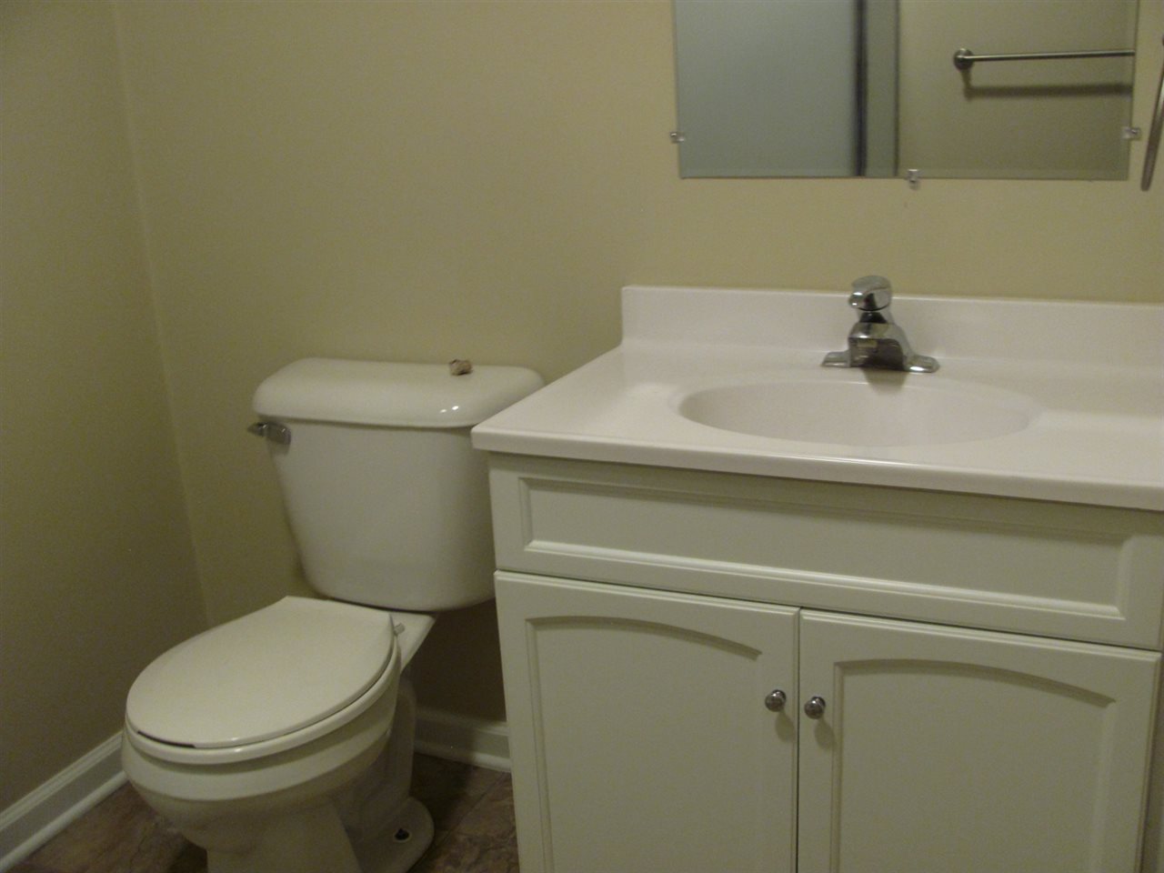 852 10th Street Beloit, WI 53511 - Photo 14 of 20 a bathroom with a sink a toilet and a mirror