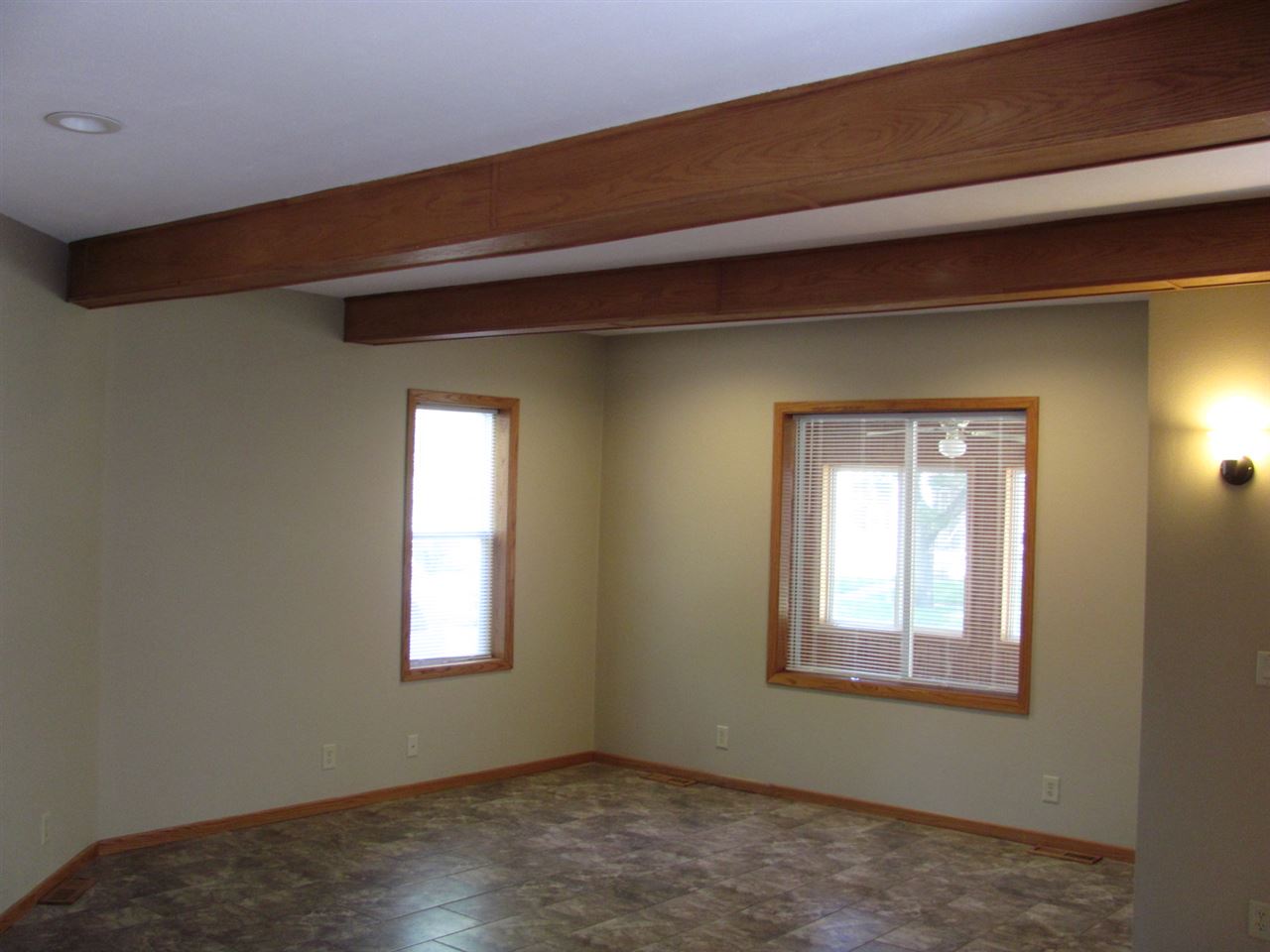 852 10th Street Beloit, WI 53511 - Photo 10 of 20 a view of an empty room with wooden floor and a window