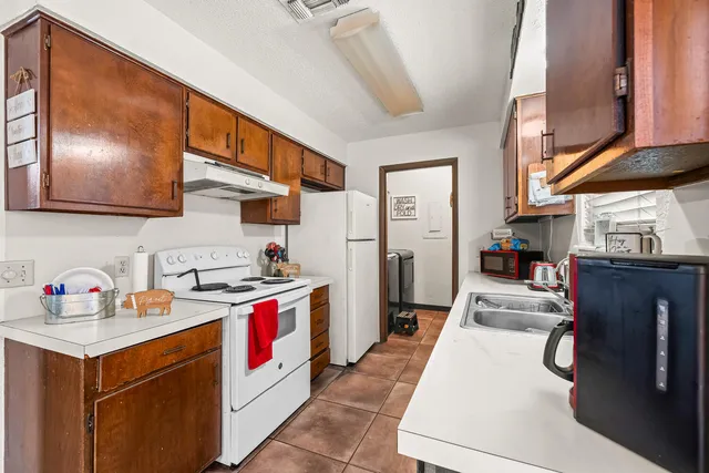 a kitchen with stainless steel appliances granite countertop a stove and a refrigerator