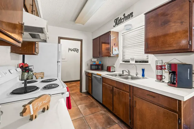 a kitchen with a sink stove and cabinets