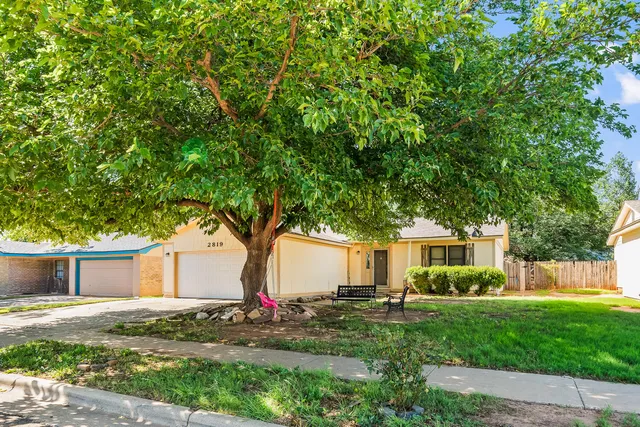 a front view of a house with a yard and a garage