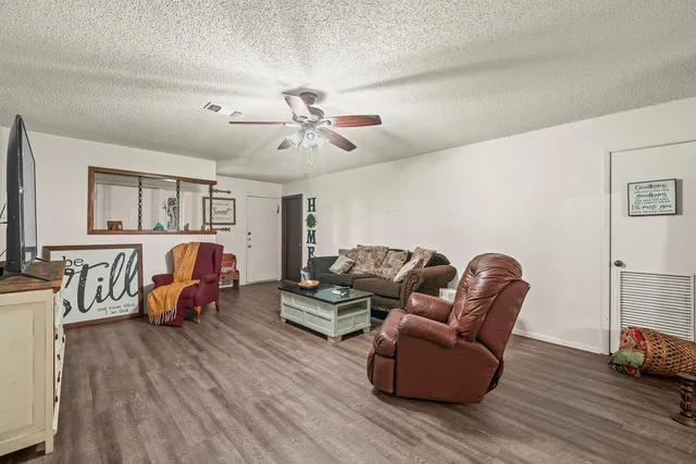 a living room with furniture and wooden floor