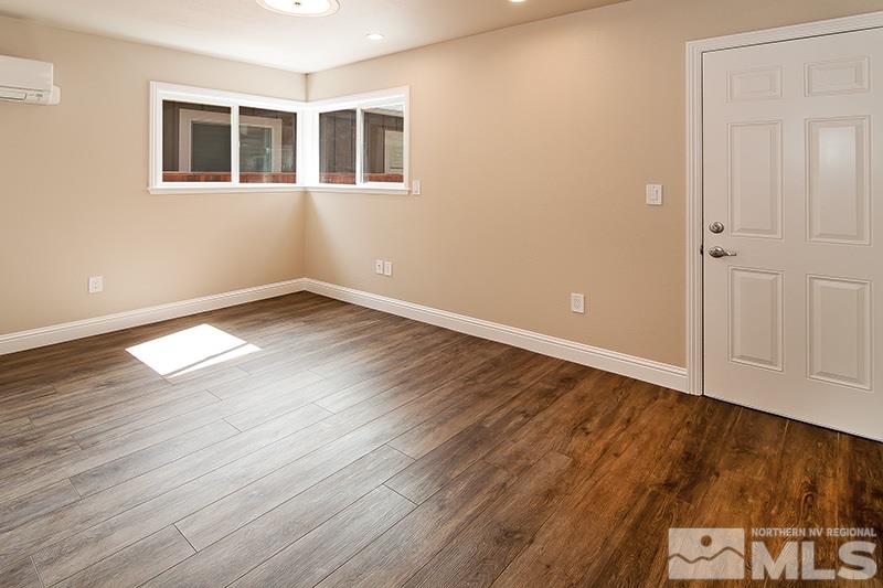 72 Caliente Street Reno, NV 89509 - Photo 6 of 12 a view of an empty room with wooden floor and a window