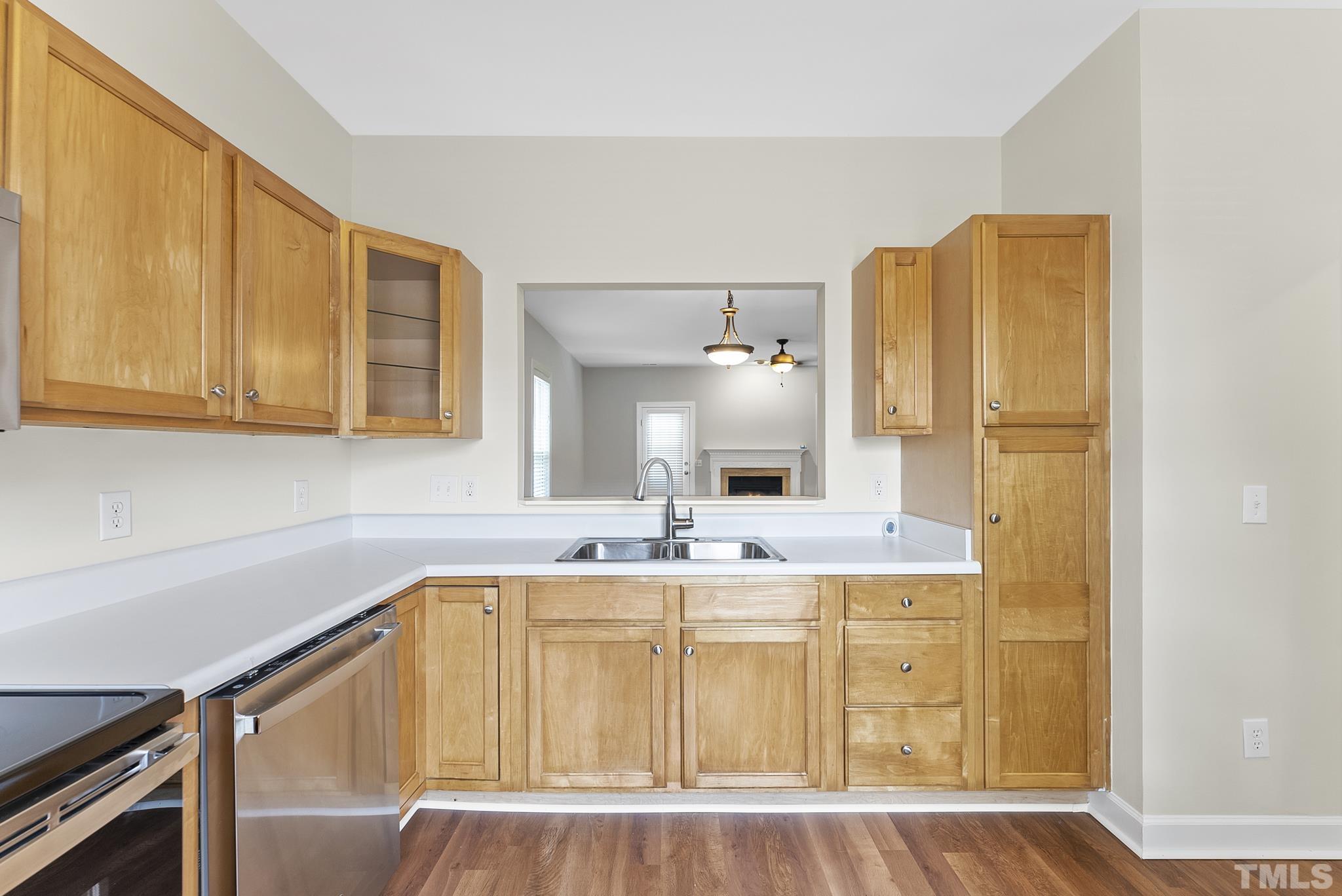 8706 Leeds Forest Lane Raleigh, NC 27615 - Photo 14 of 22 a kitchen with a sink cabinets and wooden floor