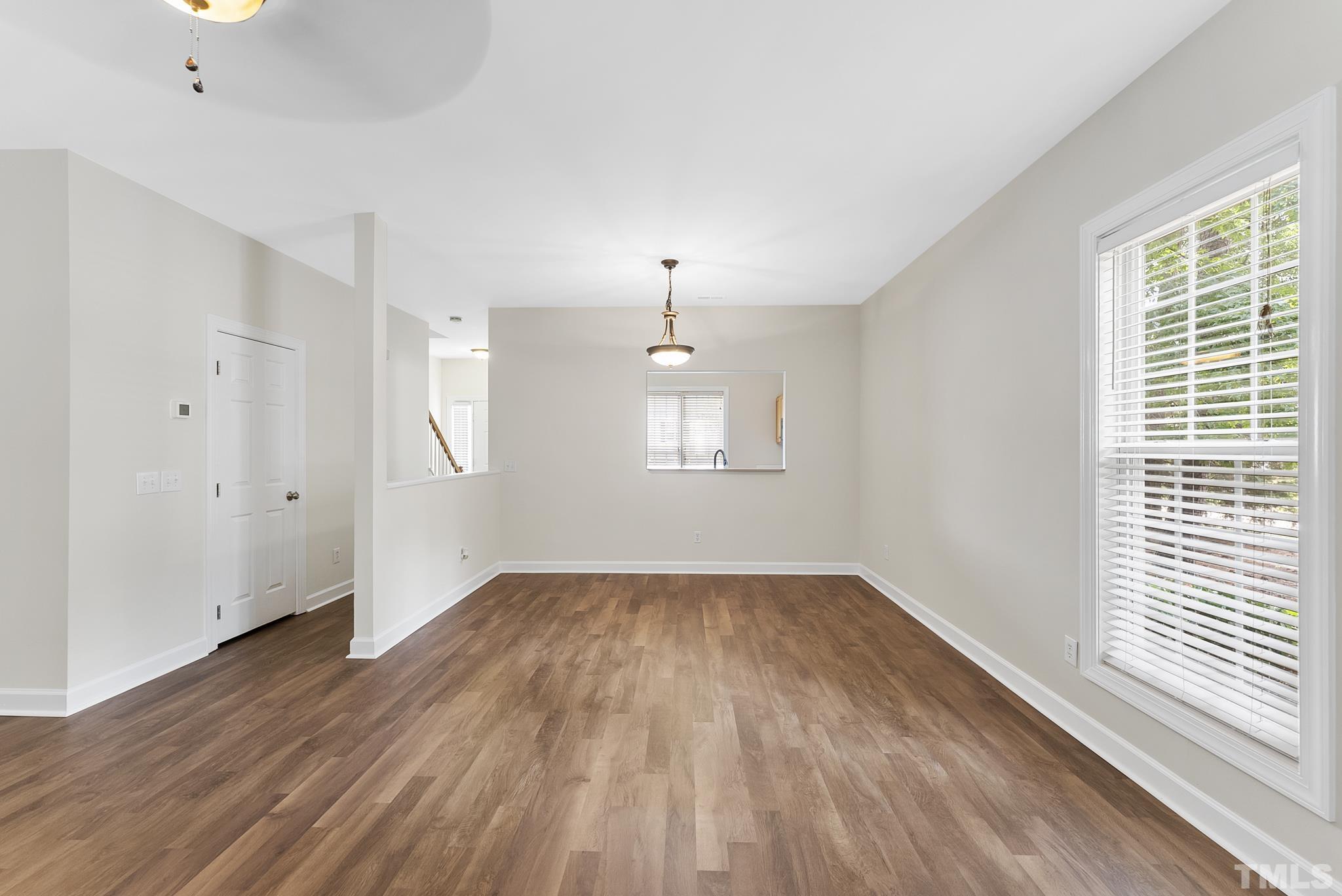 8706 Leeds Forest Lane Raleigh, NC 27615 - Photo 18 of 22 an empty room with wooden floor and windows
