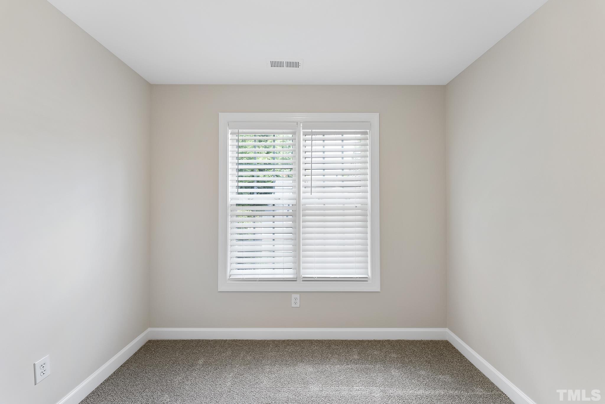 8706 Leeds Forest Lane Raleigh, NC 27615 - Photo 7 of 22 an empty room with a window