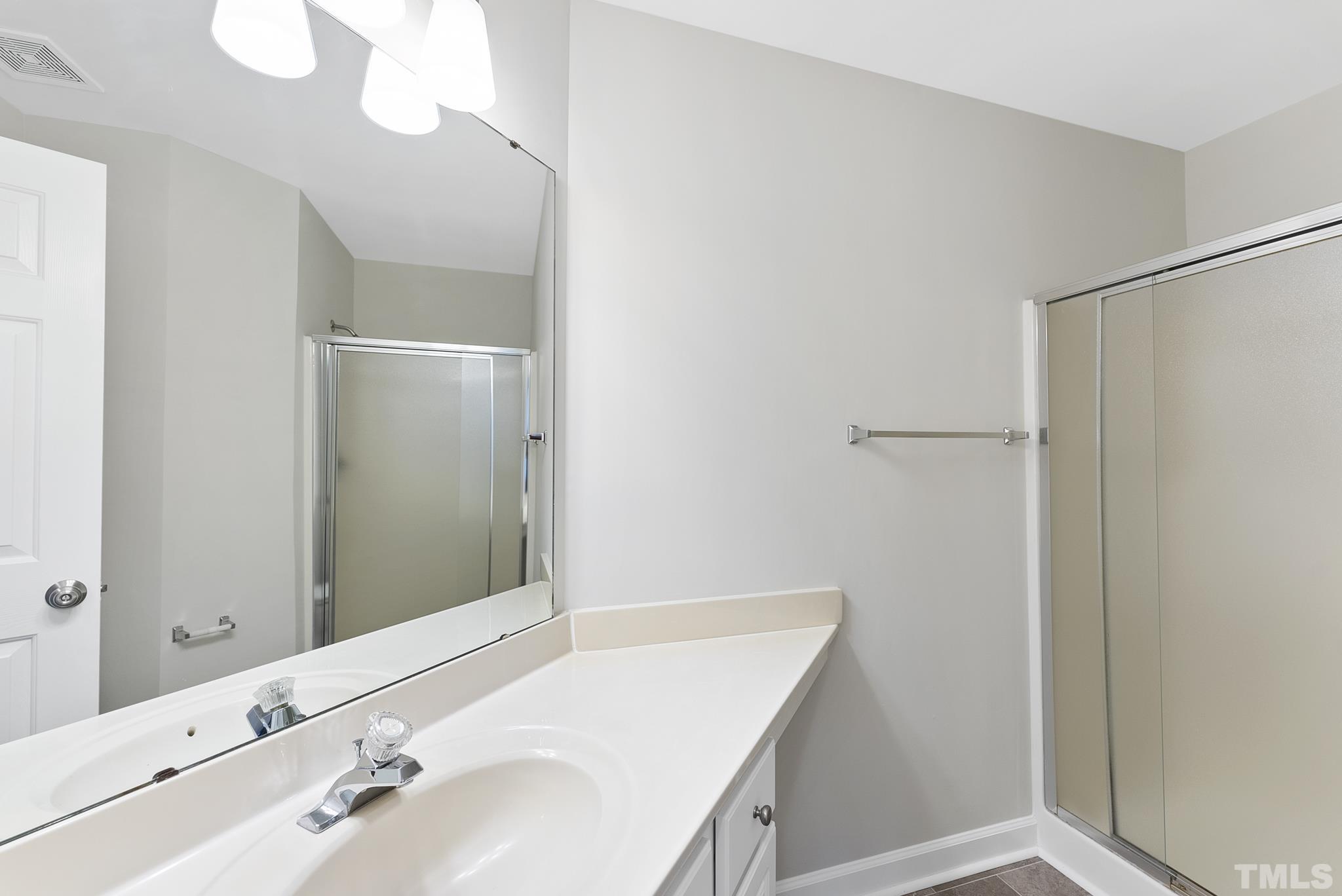 8706 Leeds Forest Lane Raleigh, NC 27615 - Photo 8 of 22 a bathroom with a sink and a mirror