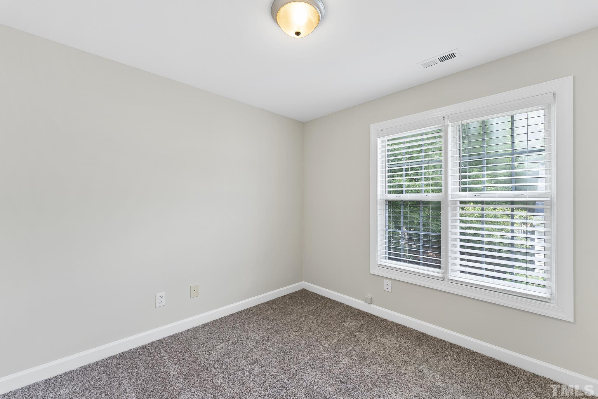 8706 Leeds Forest Lane Raleigh, NC 27615 - Photo 9 of 22 an empty room with window and windows