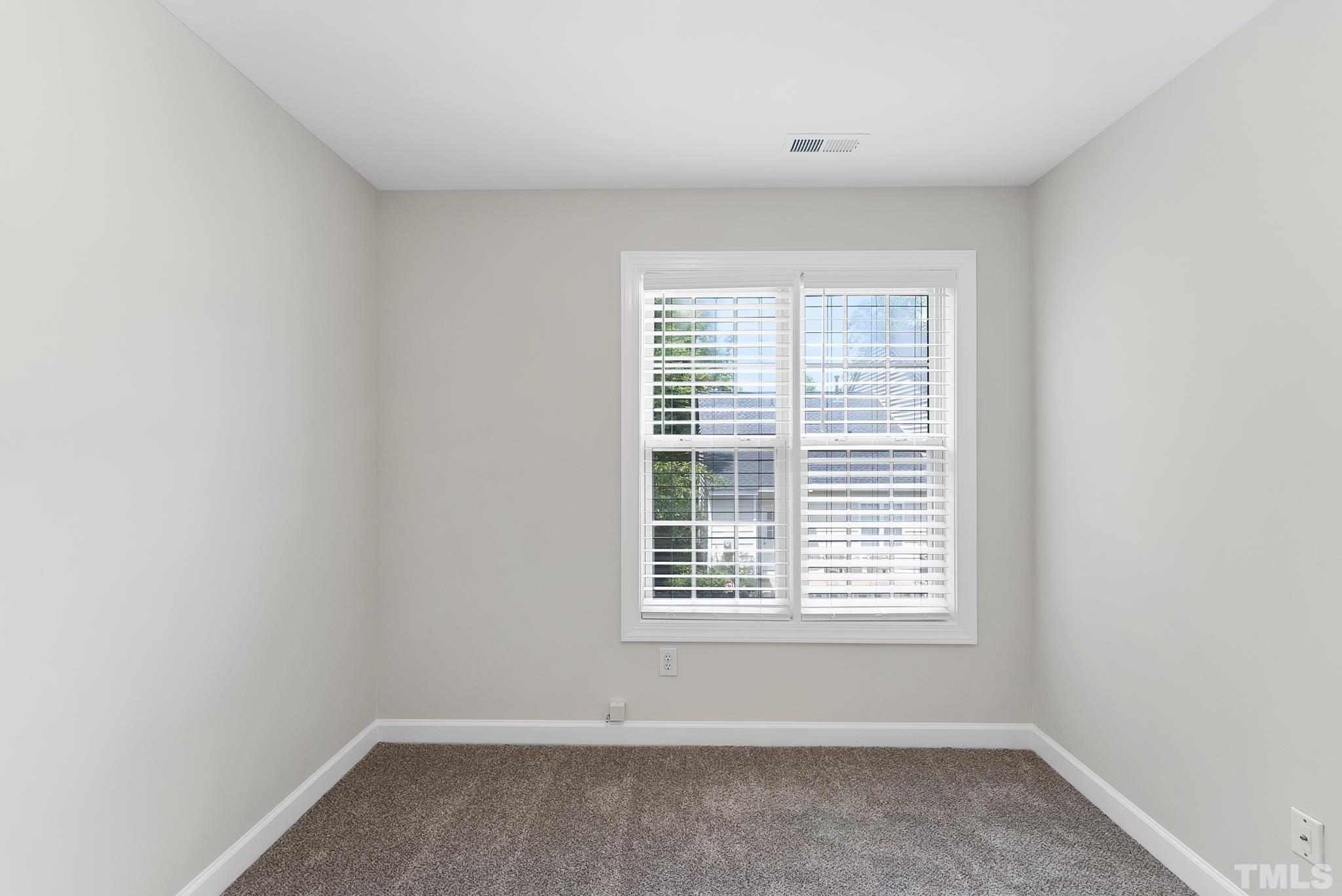 8706 Leeds Forest Lane Raleigh, NC 27615 - Photo 10 of 22 an empty room with a window