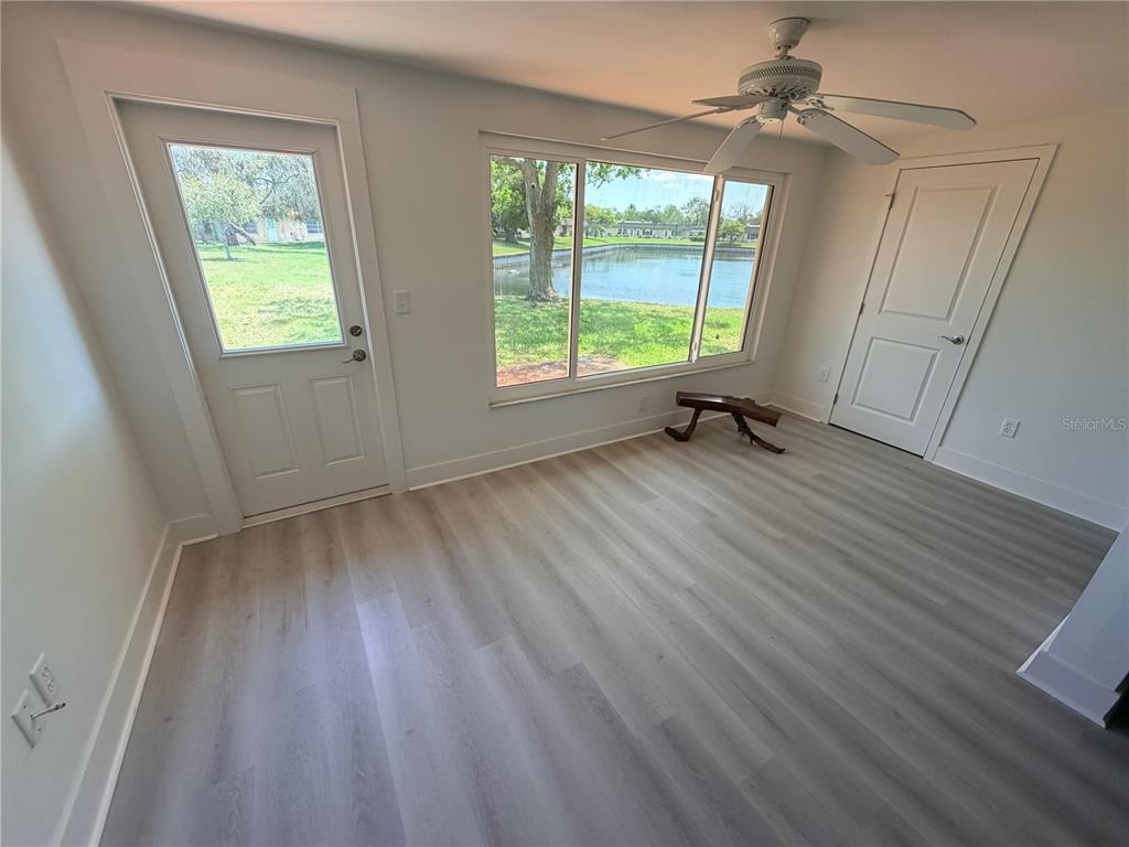 4446 Rustic Drive, Unit E New Port Richey, FL 34652 - Photo 7 of 12 a view of room with window and hardwood floor