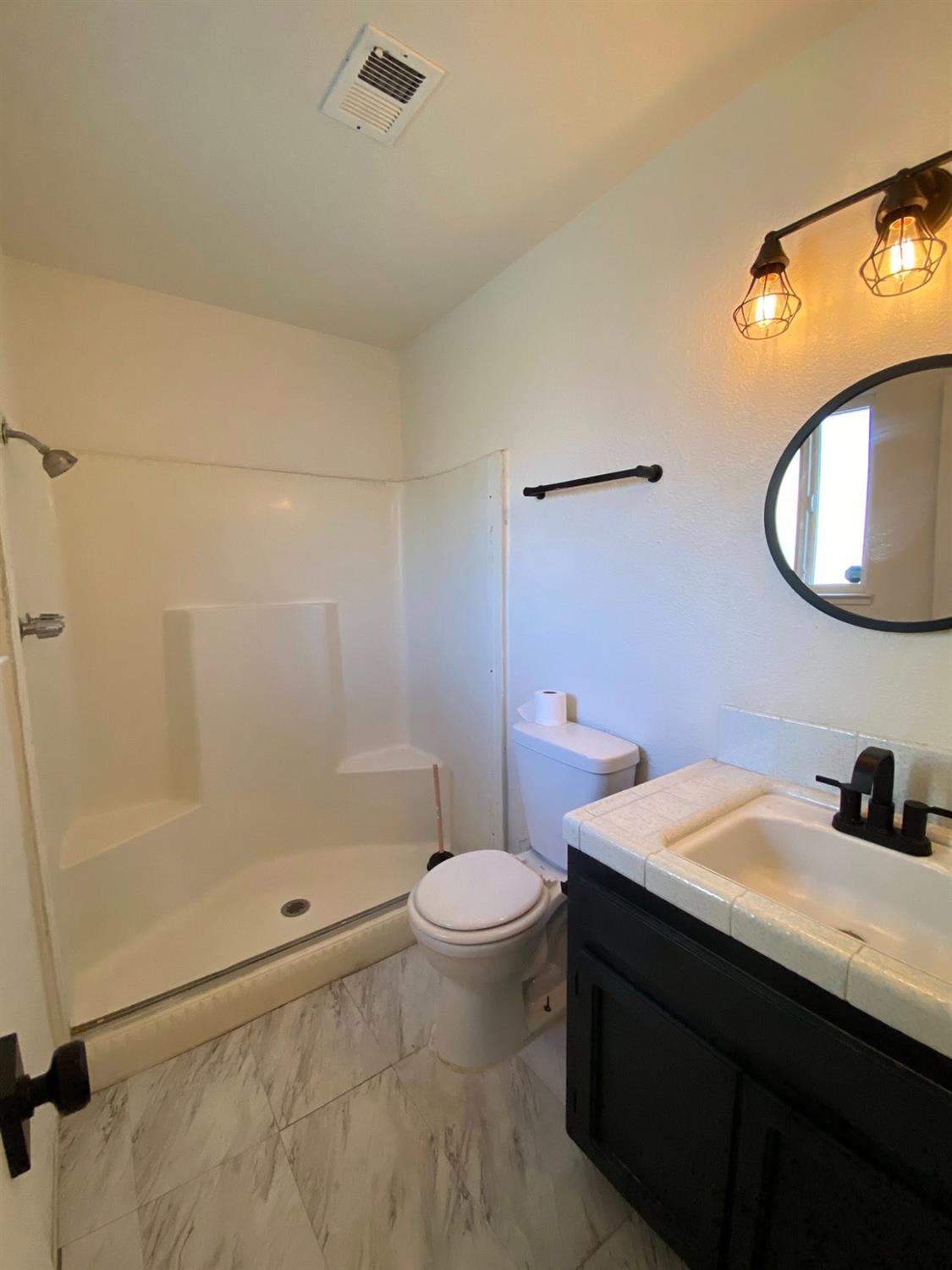 1201 Chateaugay Drive Modesto, CA 95356 - Photo 16 of 32 a bathroom with a sink toilet and shower