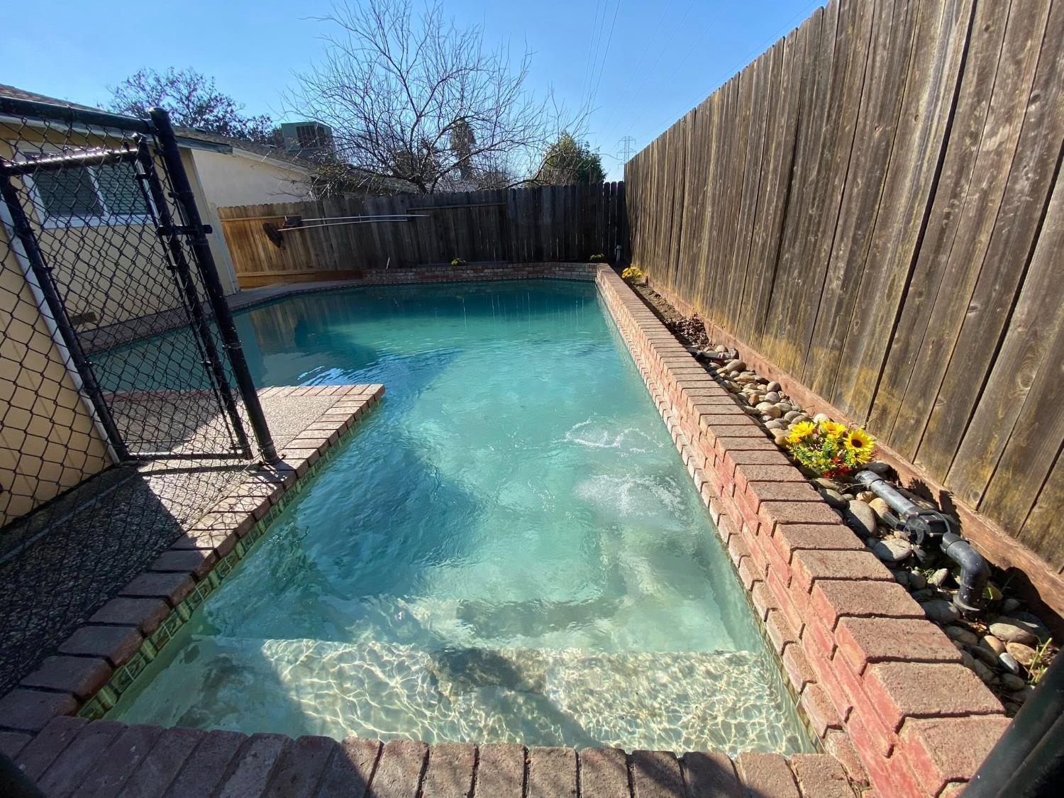 1201 Chateaugay Drive Modesto, CA 95356 - Photo 25 of 32 a view of a backyard with wooden fence