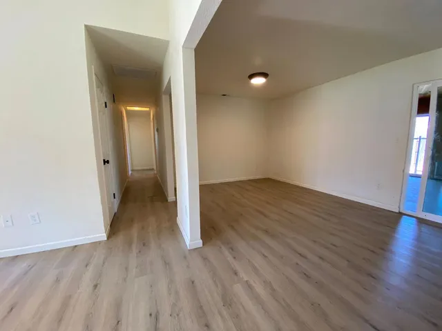 wooden floor in an empty room with a window