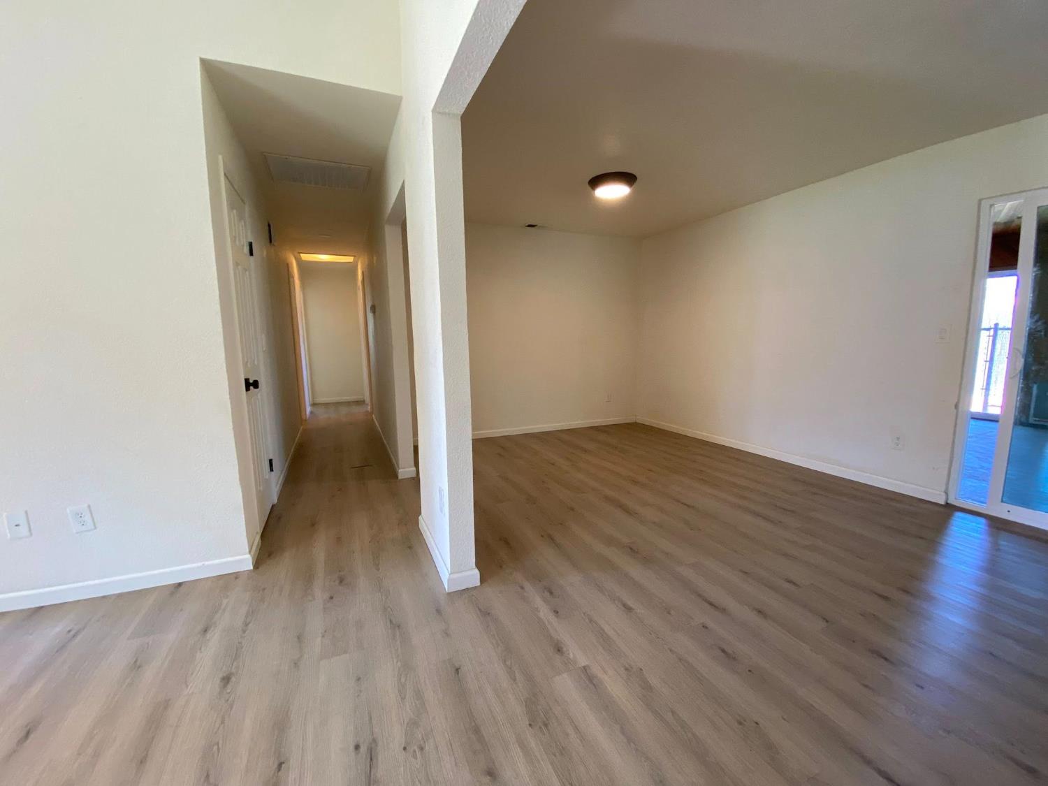 1201 Chateaugay Drive Modesto, CA 95356 - Photo 9 of 32 wooden floor in an empty room with a window