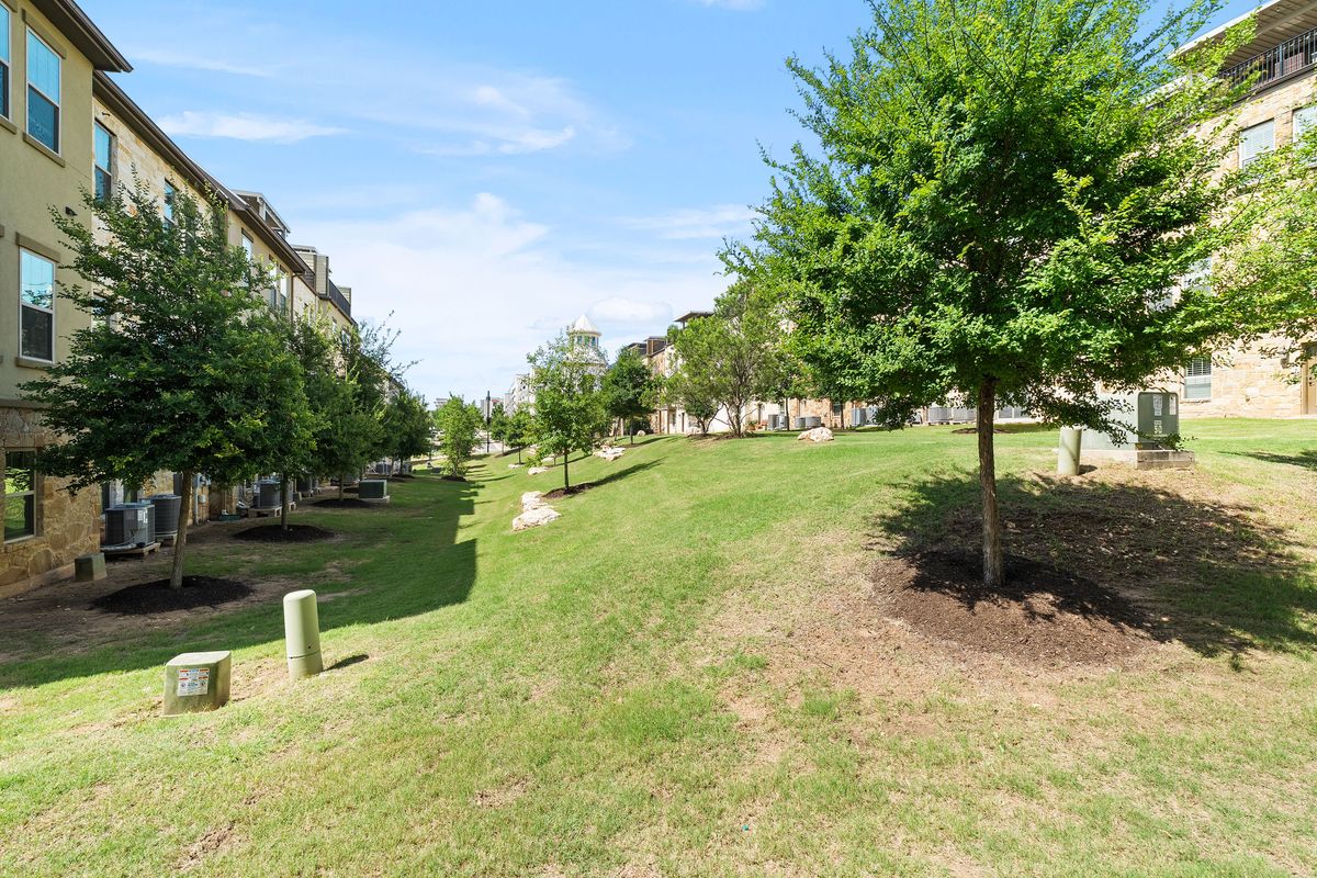 1116 Highknoll Lane Georgetown, TX 78628 - Photo 27 of 36 a backyard of a house with lots of green space and fountain
