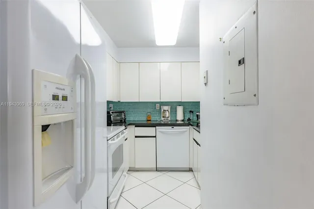 a kitchen with stainless steel appliances a stove a refrigerator and cabinets