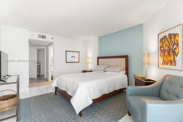 a bedroom with bed and a couch